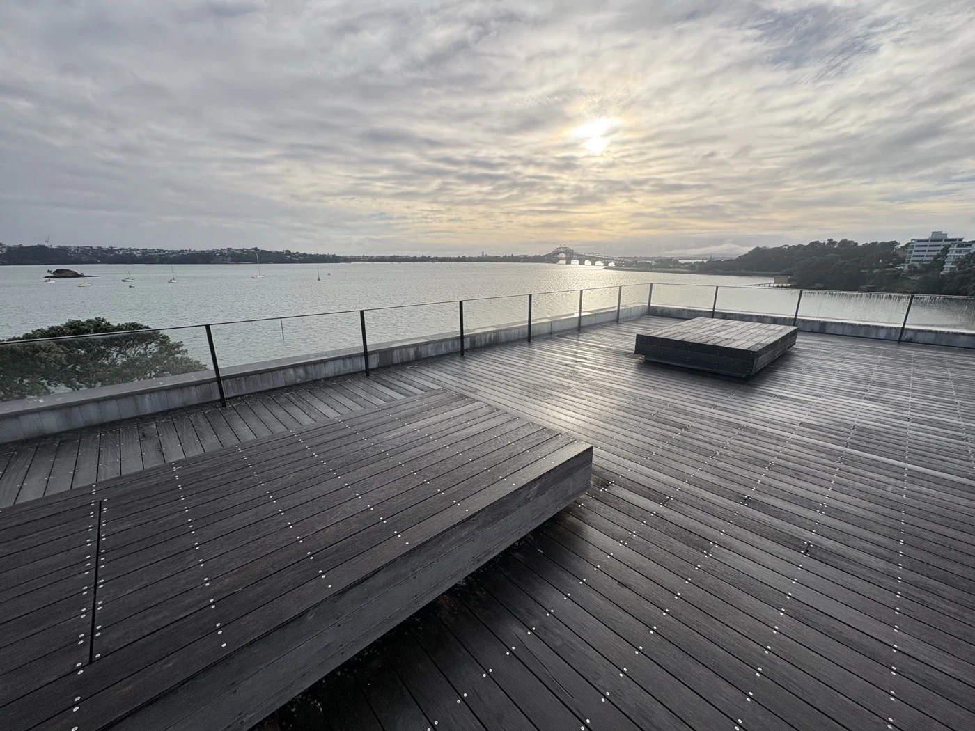 Clean glass balustrade on a harbourside Auckland deck looking towards the Harbour Bridge